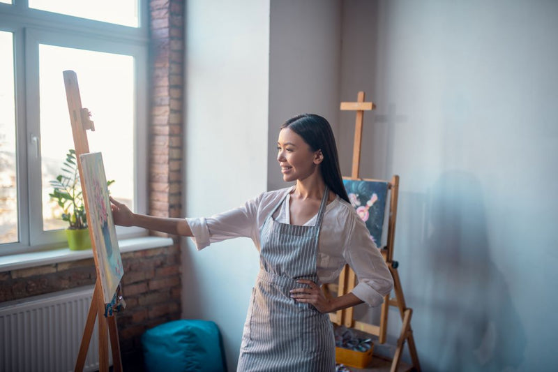 woman-standing-in-front-her-painting